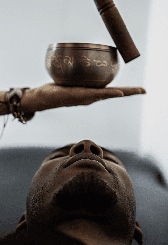 Person relaxing with a Tibetan singing bowl.